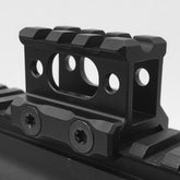 Riser mount showing 1 inch saddle height and three Picatinny slots